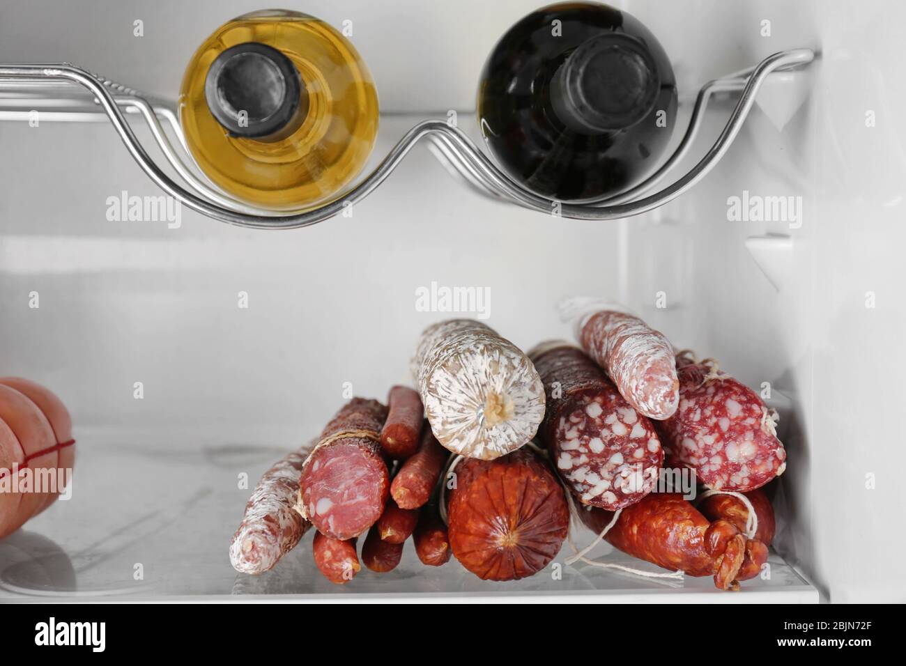 Smoked sausages on shelf in refrigerator Stock Photo Alamy
