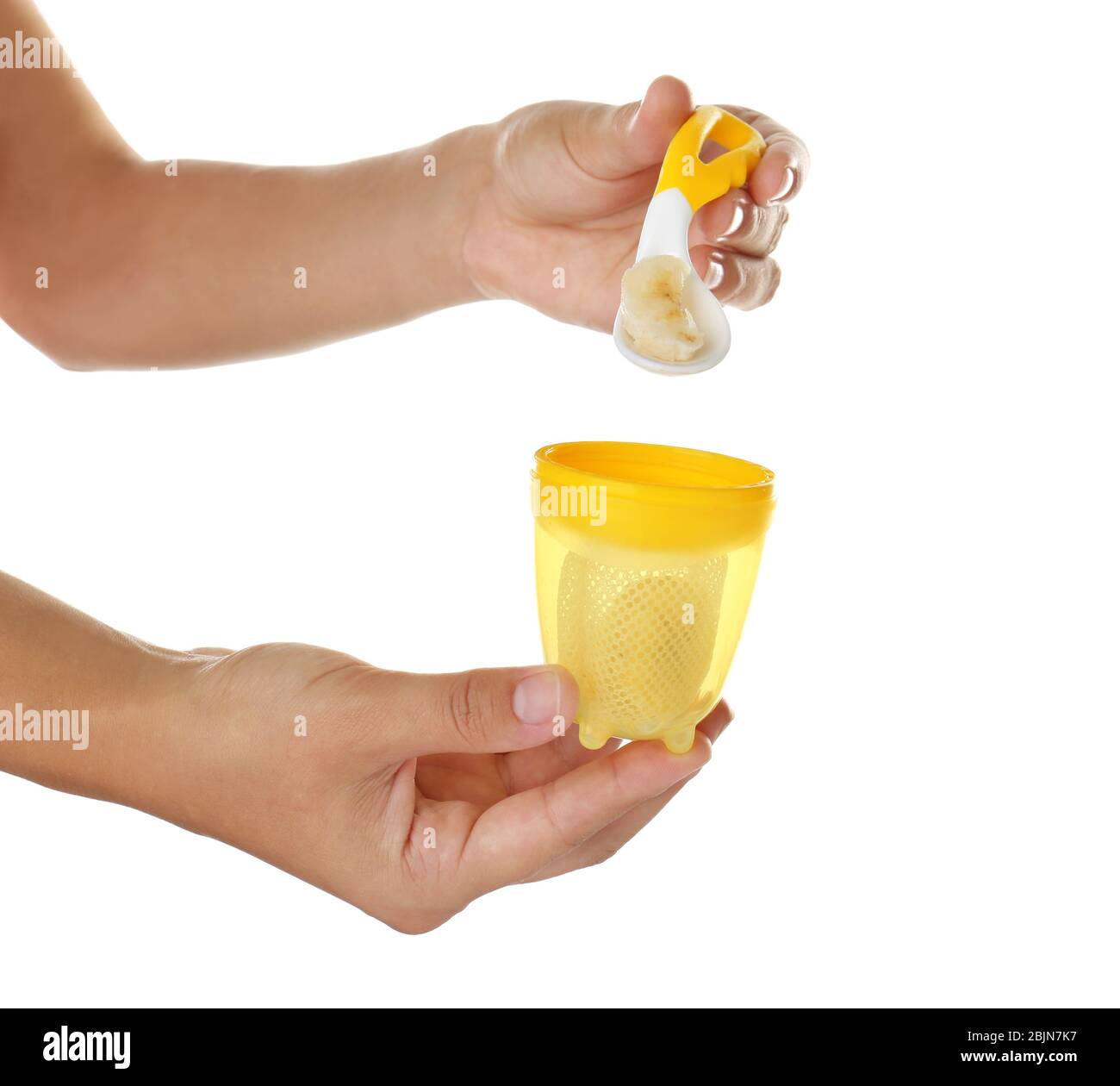 Woman filling baby's nibbler on white background Stock Photo Alamy