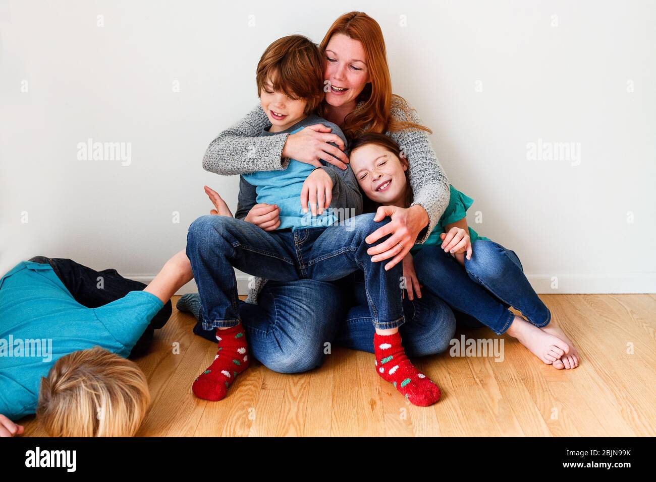 Portrait of a mother with her three children Stock Photo