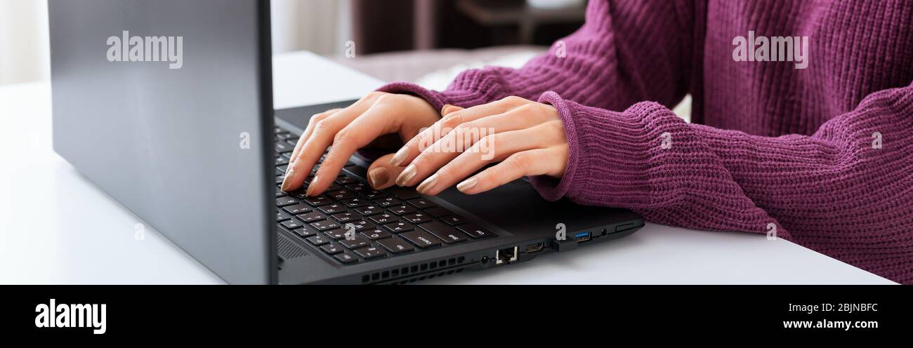 Woman working or learning from home using laptop. Freelancer have remote work, online education, work on maternity leave. Female hands typing on Stock Photo