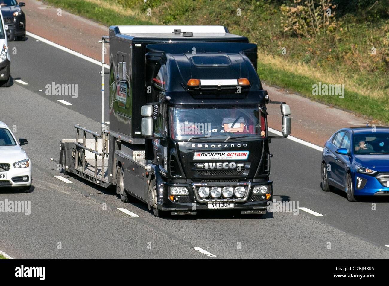 Bickers Action, Film & Tv Action; Eurocargo Haulage delivery trucks, lorry, transportation, truck, cargo carrier, Iveco vehicle, European commercial transport, industry, M6 at Lancaster, UK Stock Photo