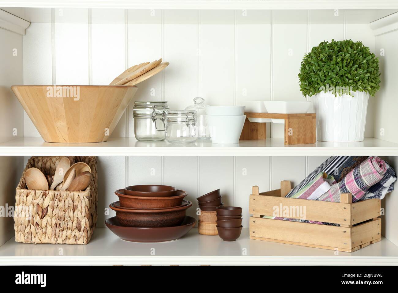 Different kitchenware on shelves Stock Photo - Alamy