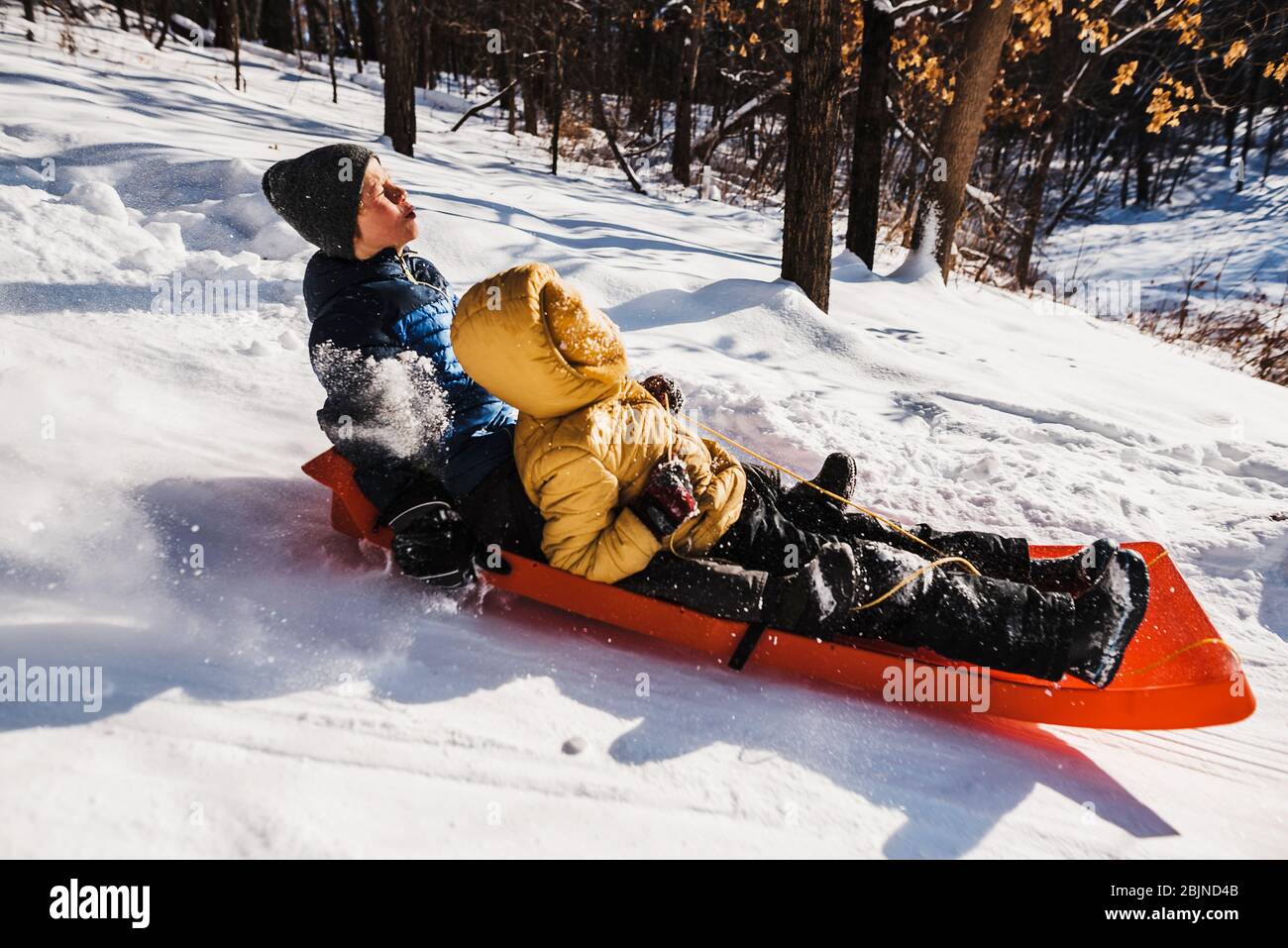 Two boys sledding down a hill, USA Stock Photo Alamy