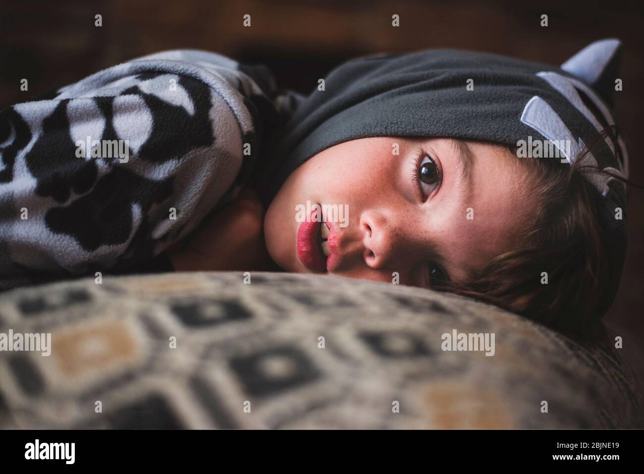 Close-up of a boy lying on a sofa Stock Photo