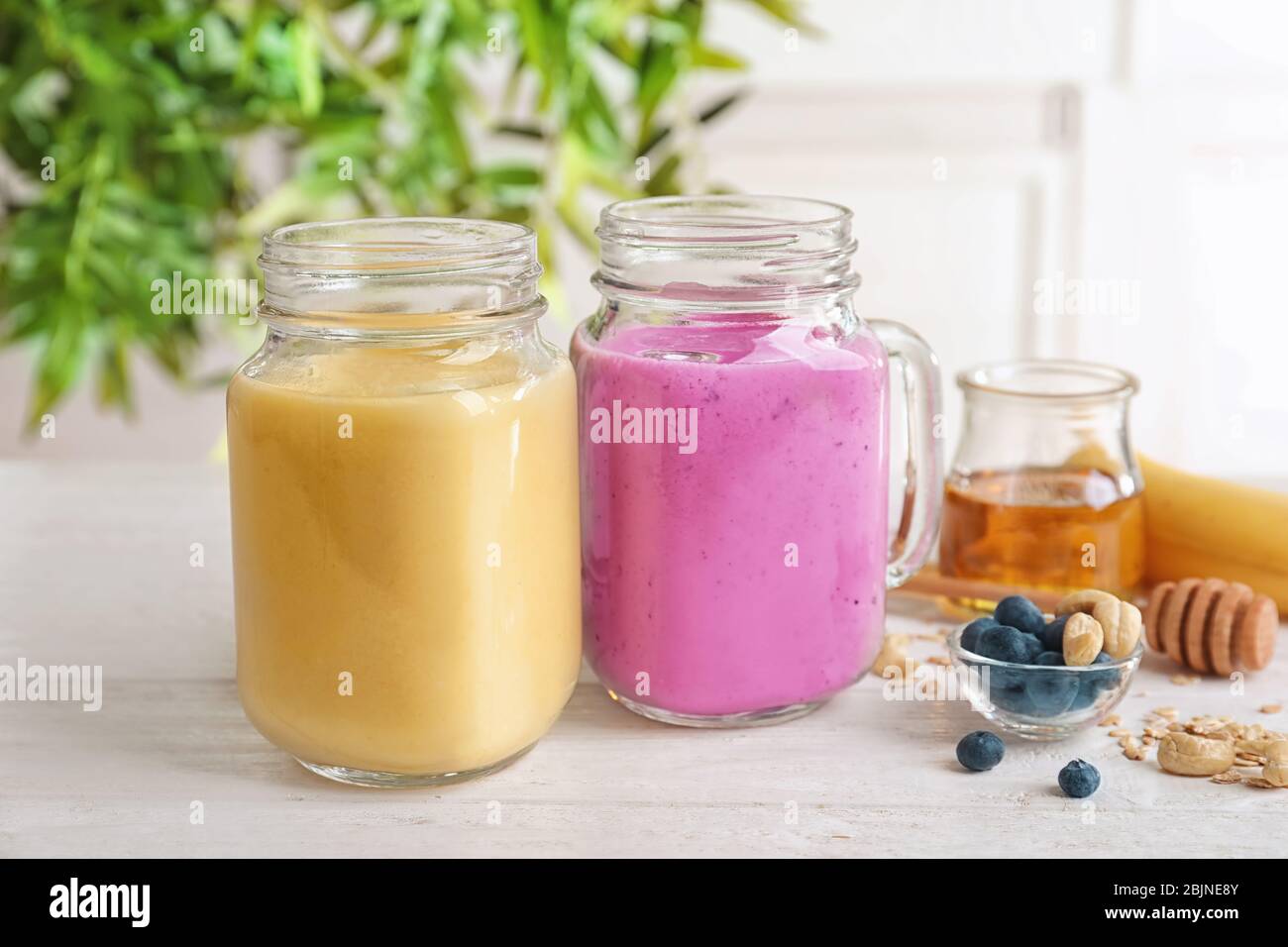 Jars with different protein shakes on table Stock Photo