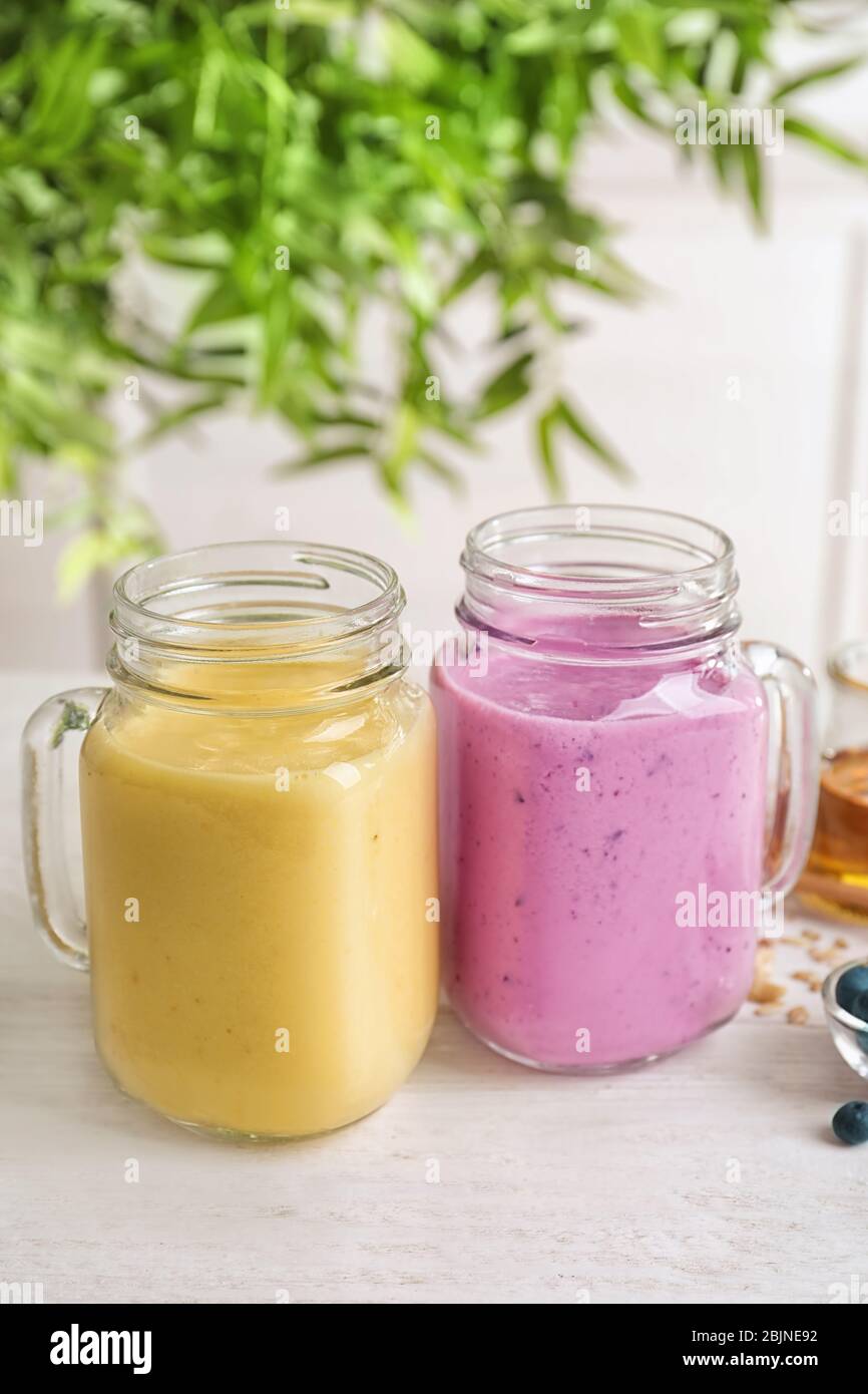 Jars with different protein shakes on table Stock Photo
