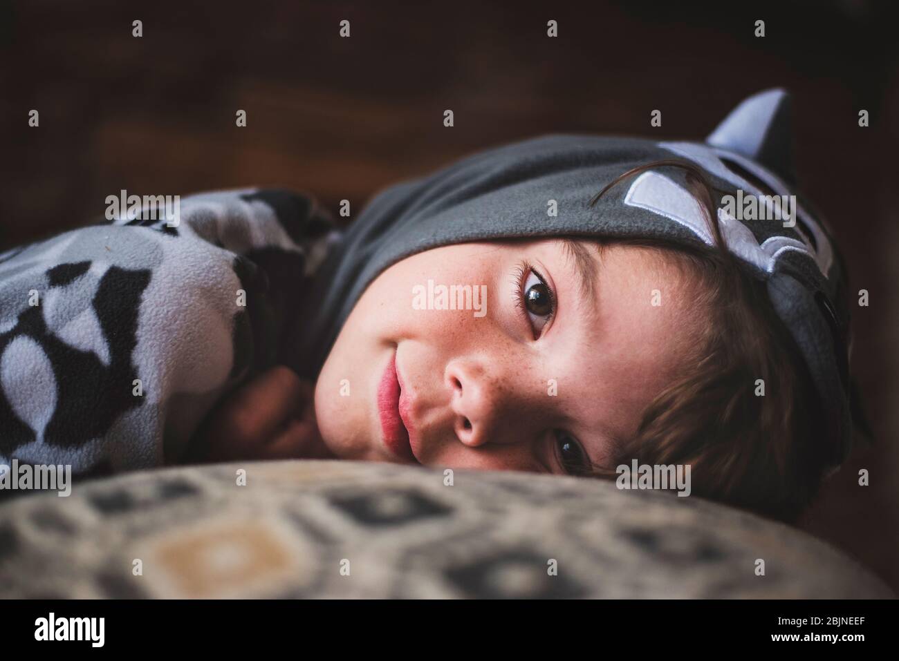 Smiling boy lying on a sofa Stock Photo