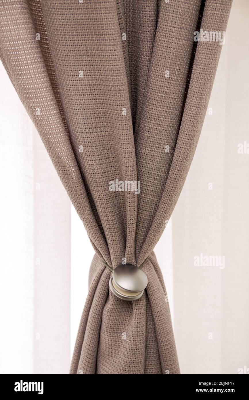 Beautiful curtains with tieback indoors, closeup Stock Photo