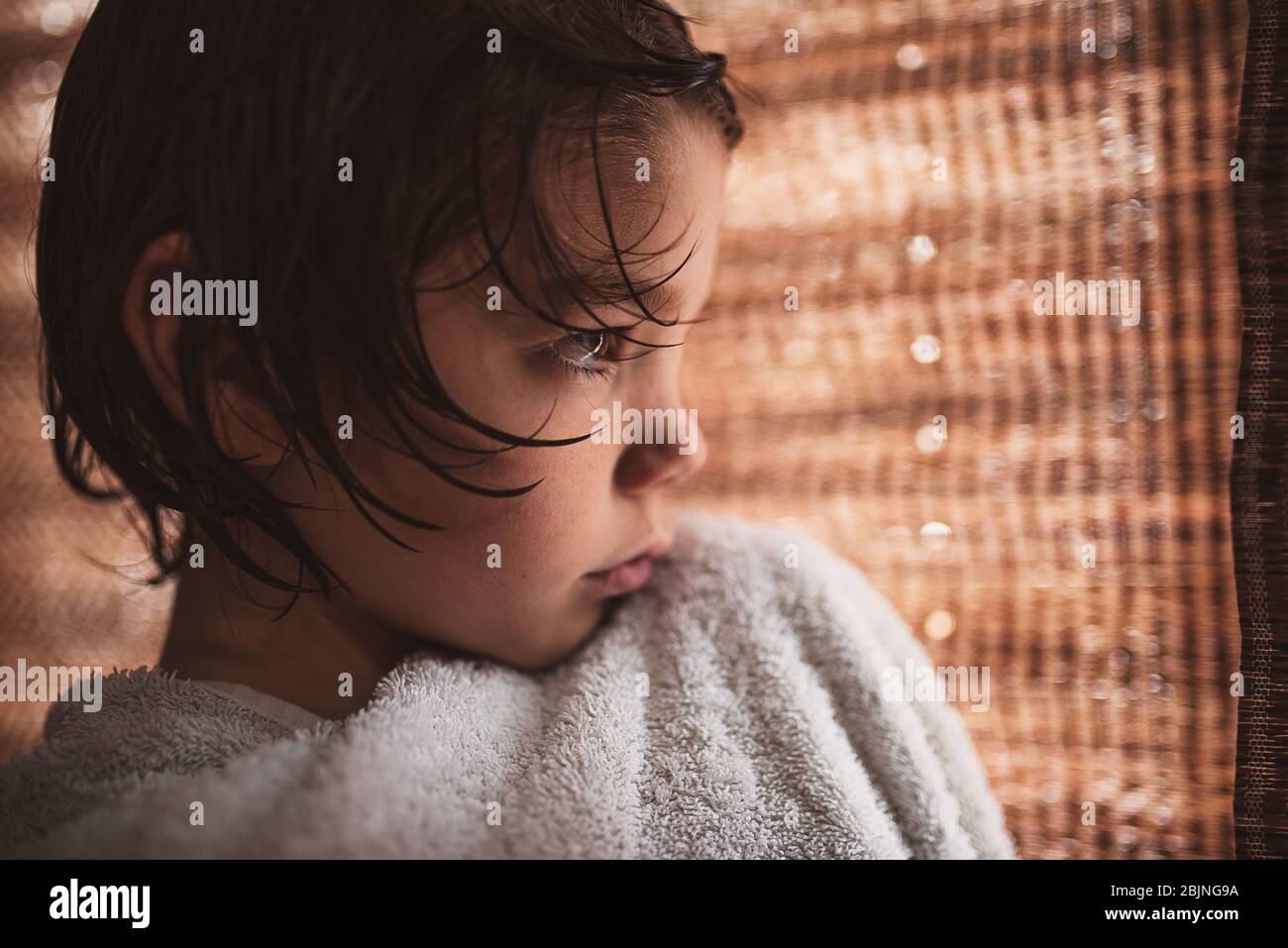 Close-up of a boy wrapped in a towel after a bath Stock Photo
