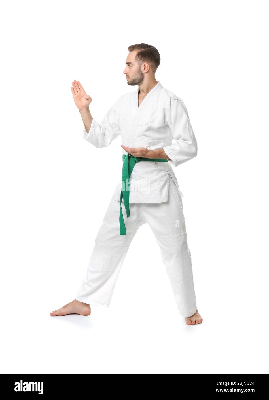 Young man practicing karate on white background Stock Photo - Alamy