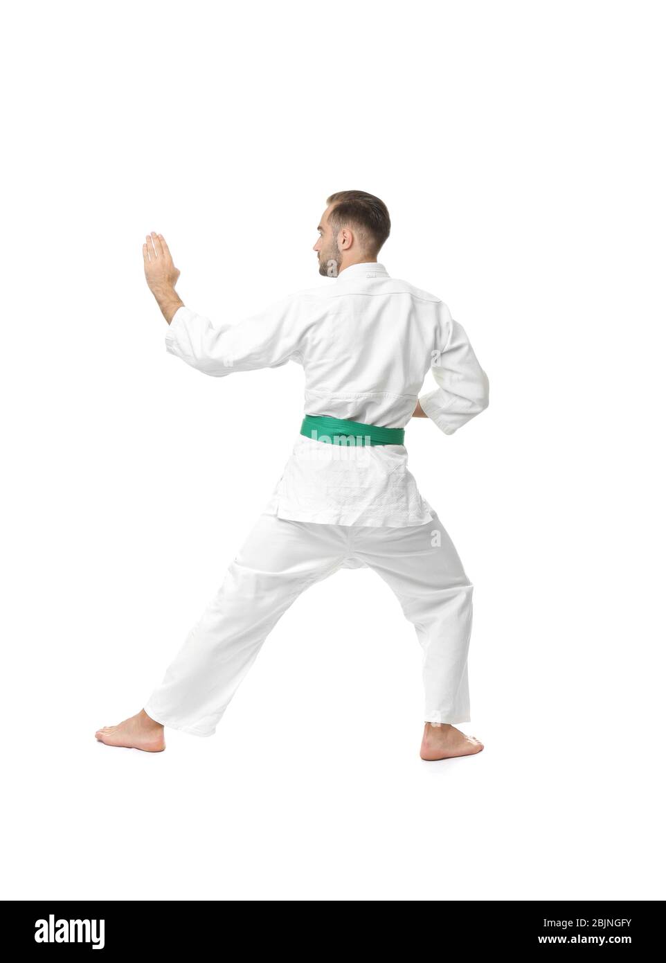 Young man practicing karate on white background Stock Photo - Alamy