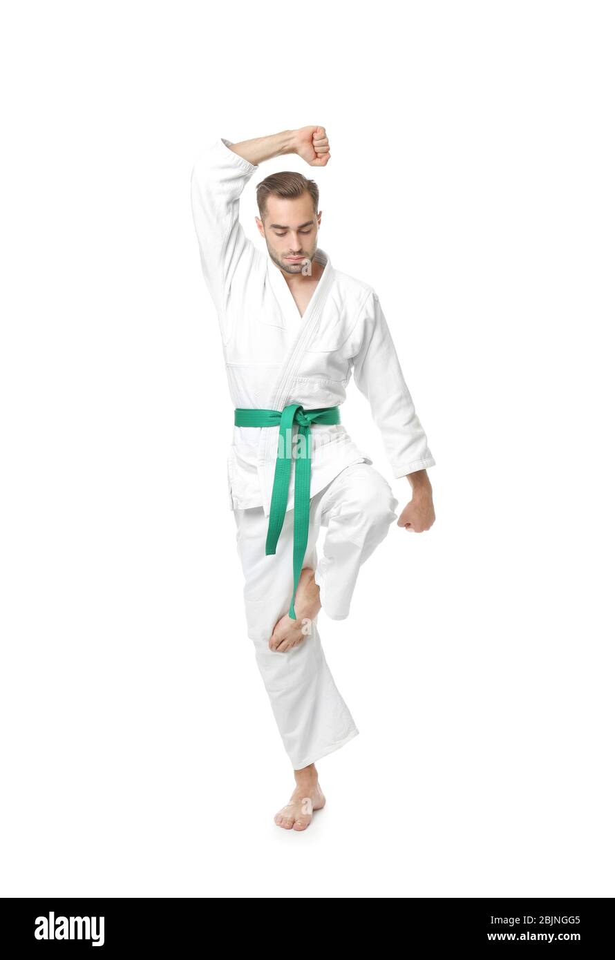 Young man practicing karate on white background Stock Photo
