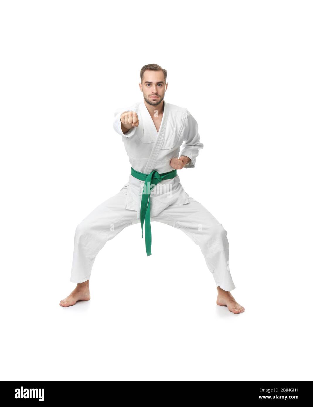 Young man practicing karate on white background Stock Photo - Alamy