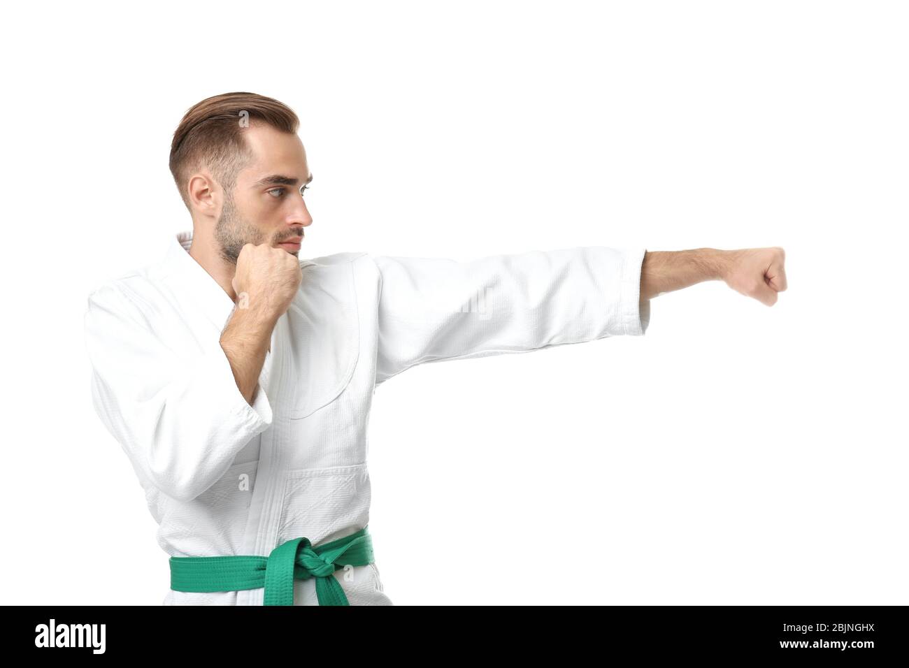 Young man practicing karate on white background Stock Photo - Alamy