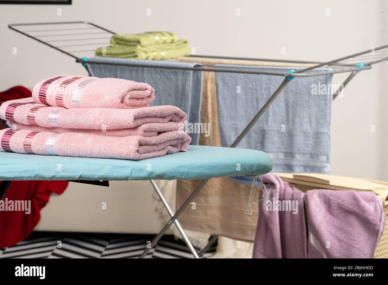 Housework concept. Ironing towels on ironing board Stock Photo Alamy