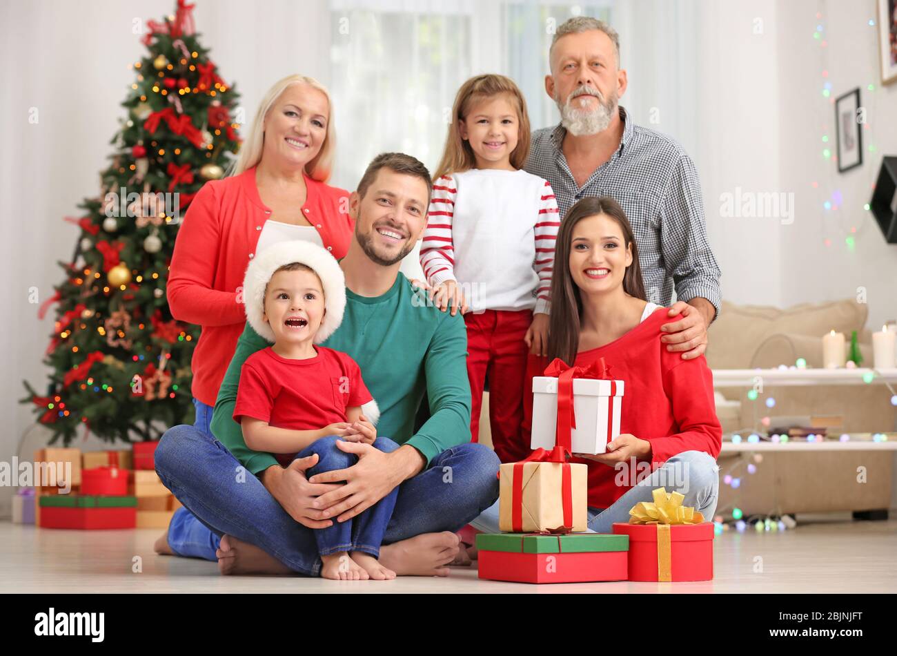 Happy family with Christmas gifts at home Stock Photo - Alamy