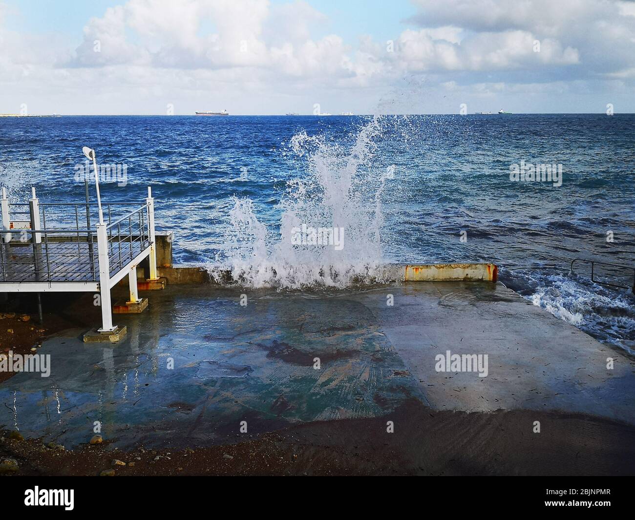 Wave crashing on waterfront, Bugibba, Malta Stock Photo