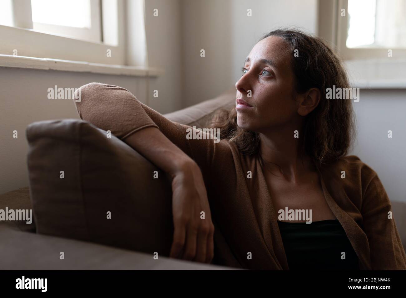 Caucasian woman spending time at home self isolating and social distancing in quarantine lockdown du Stock Photo