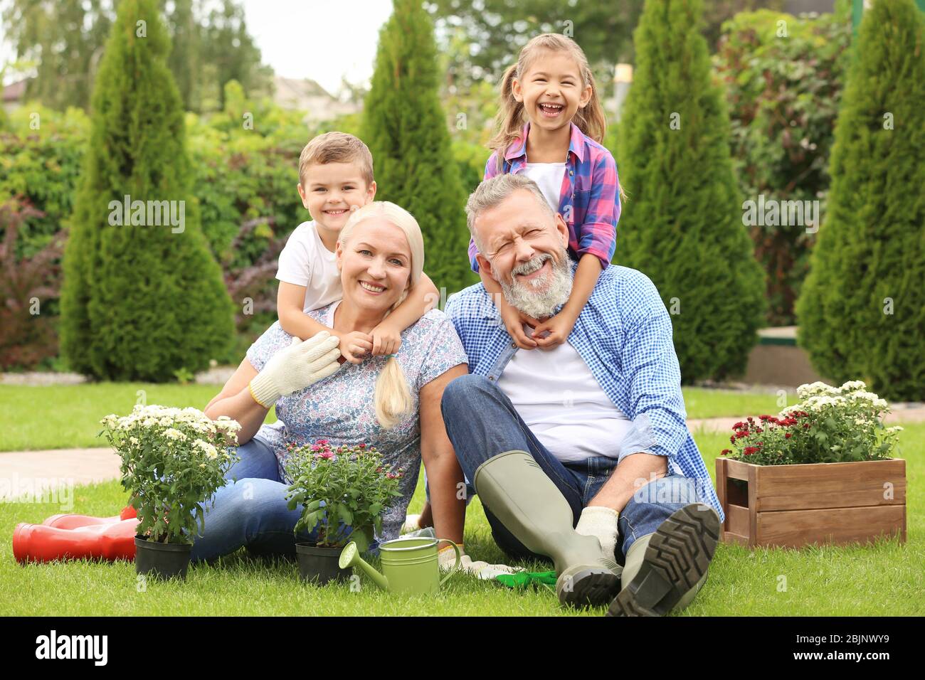 Elderly couple with grandchildren in garden Stock Photo