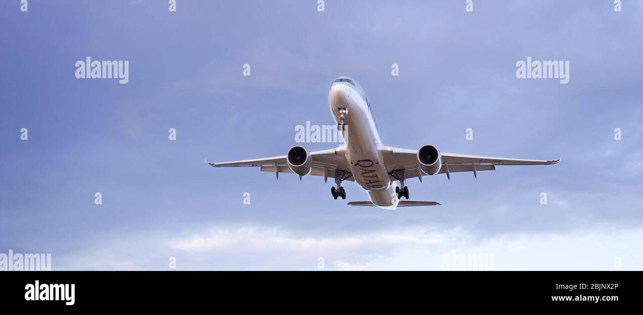 Commercial passenger jet airbus A350 of Quatar Airways landing at the airport. Stock Photo