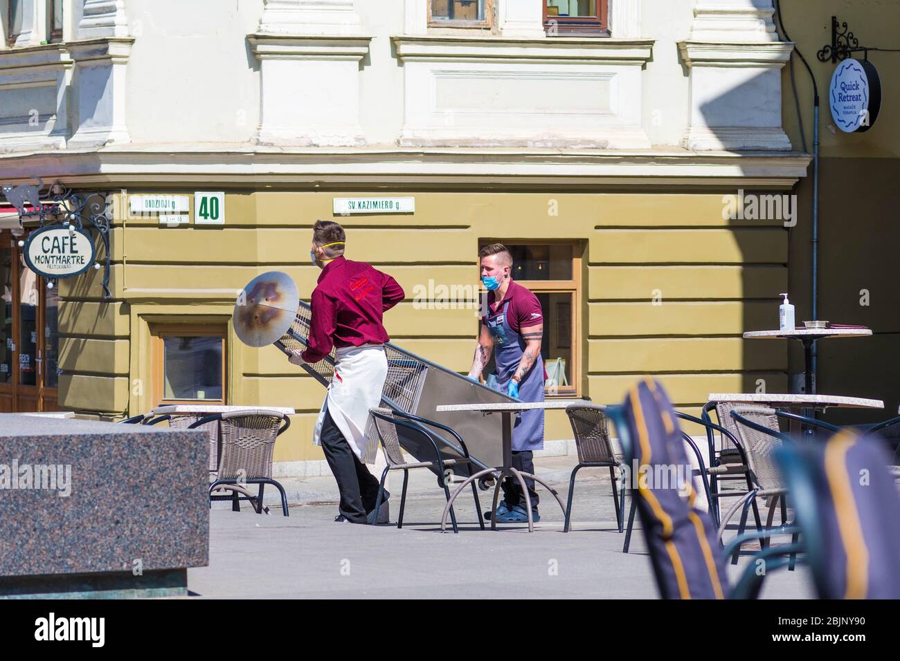 Waiters with a mask reopen an outdoor bar, café or restaurant after quarantine restrictions Stock Photo