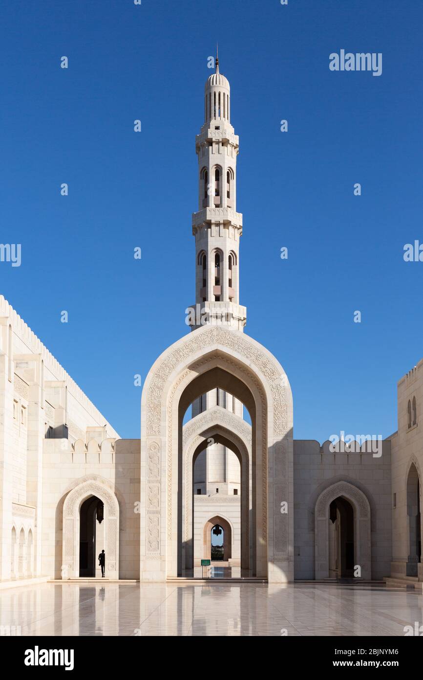 Minaret towering over archways of Sultan Qaboos Grand Mosque in Muscat, Oman Stock Photo