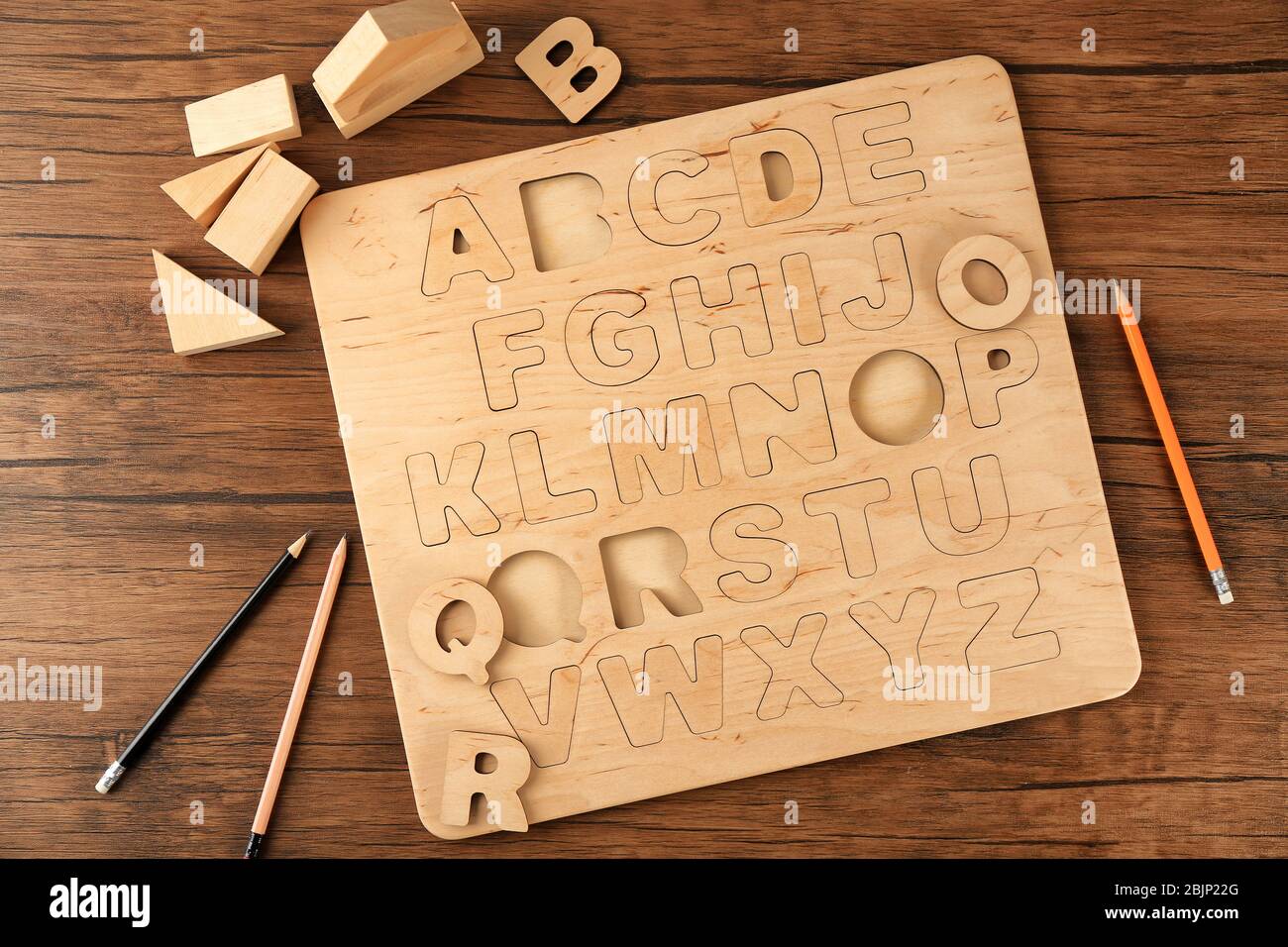 Wooden alphabet board on table Stock Photo - Alamy