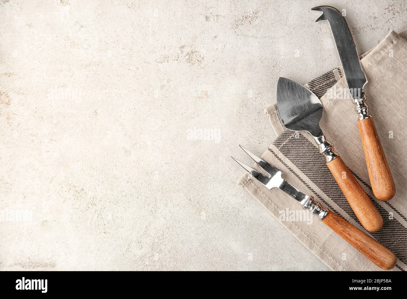 Various kitchen utensils on light textured background Stock Photo