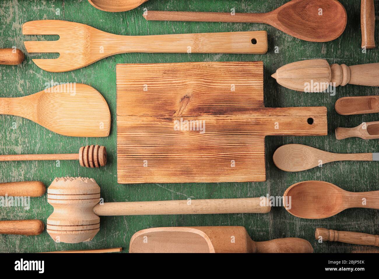 Various wooden kitchen utensils on color table Stock Photo - Alamy