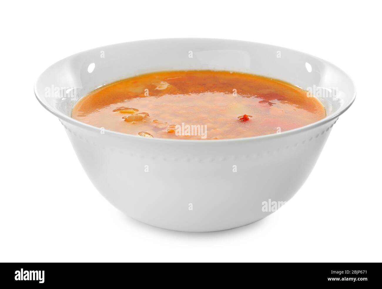 Bowl with tasty lentil soup on white background Stock Photo