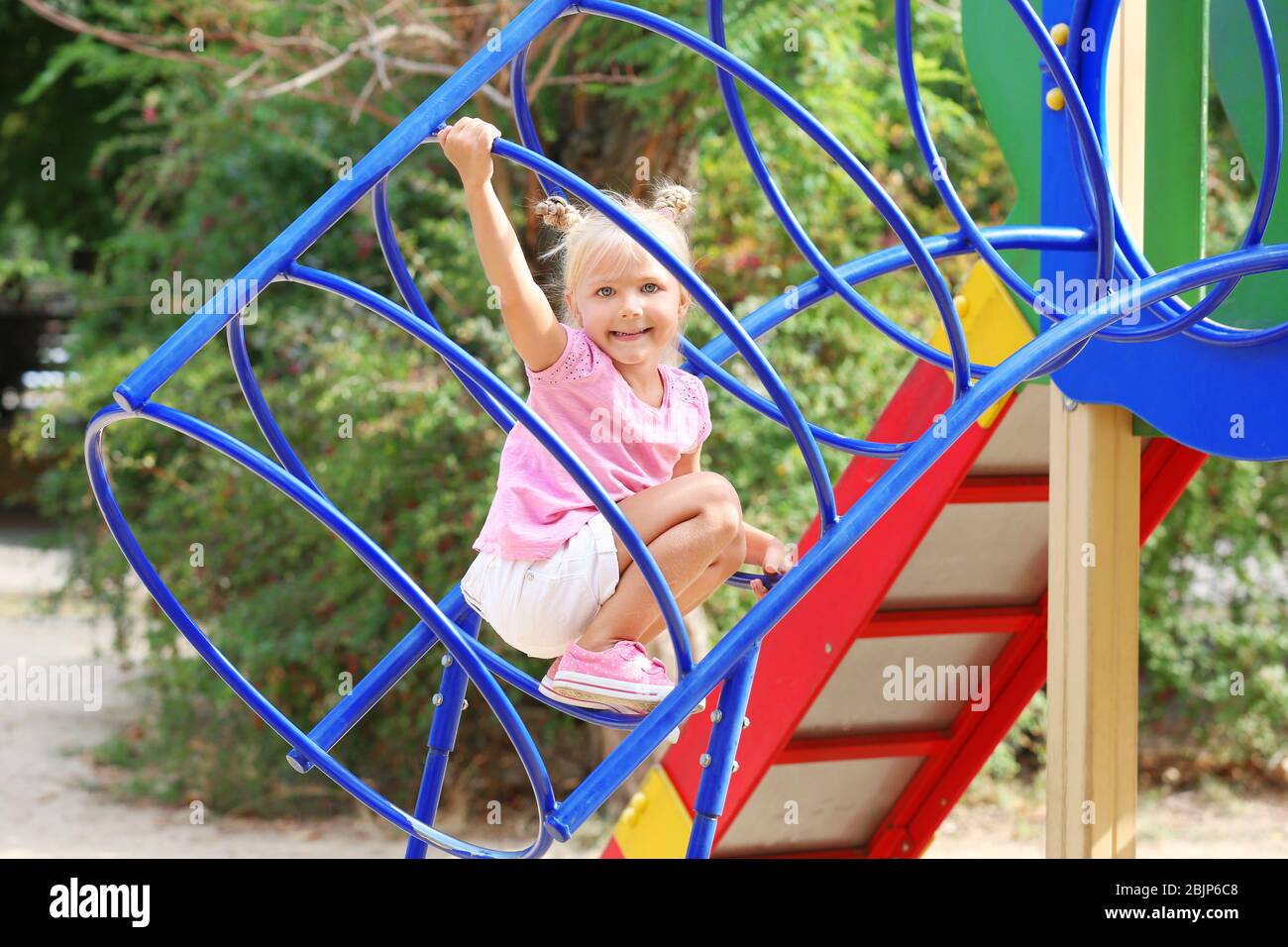Adorable little girl on playground Stock Photo - Alamy