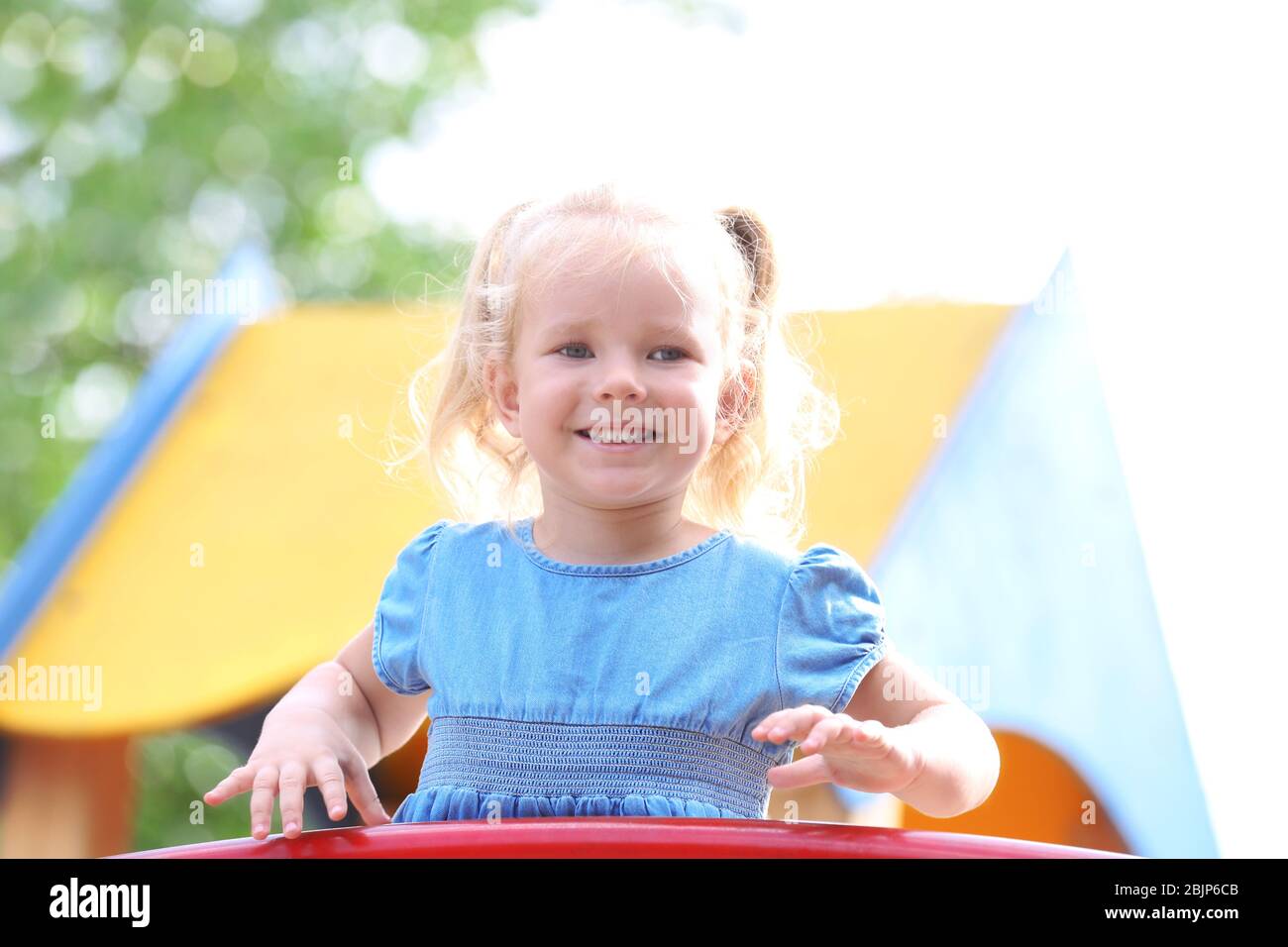 Adorable little girl on playground Stock Photo - Alamy