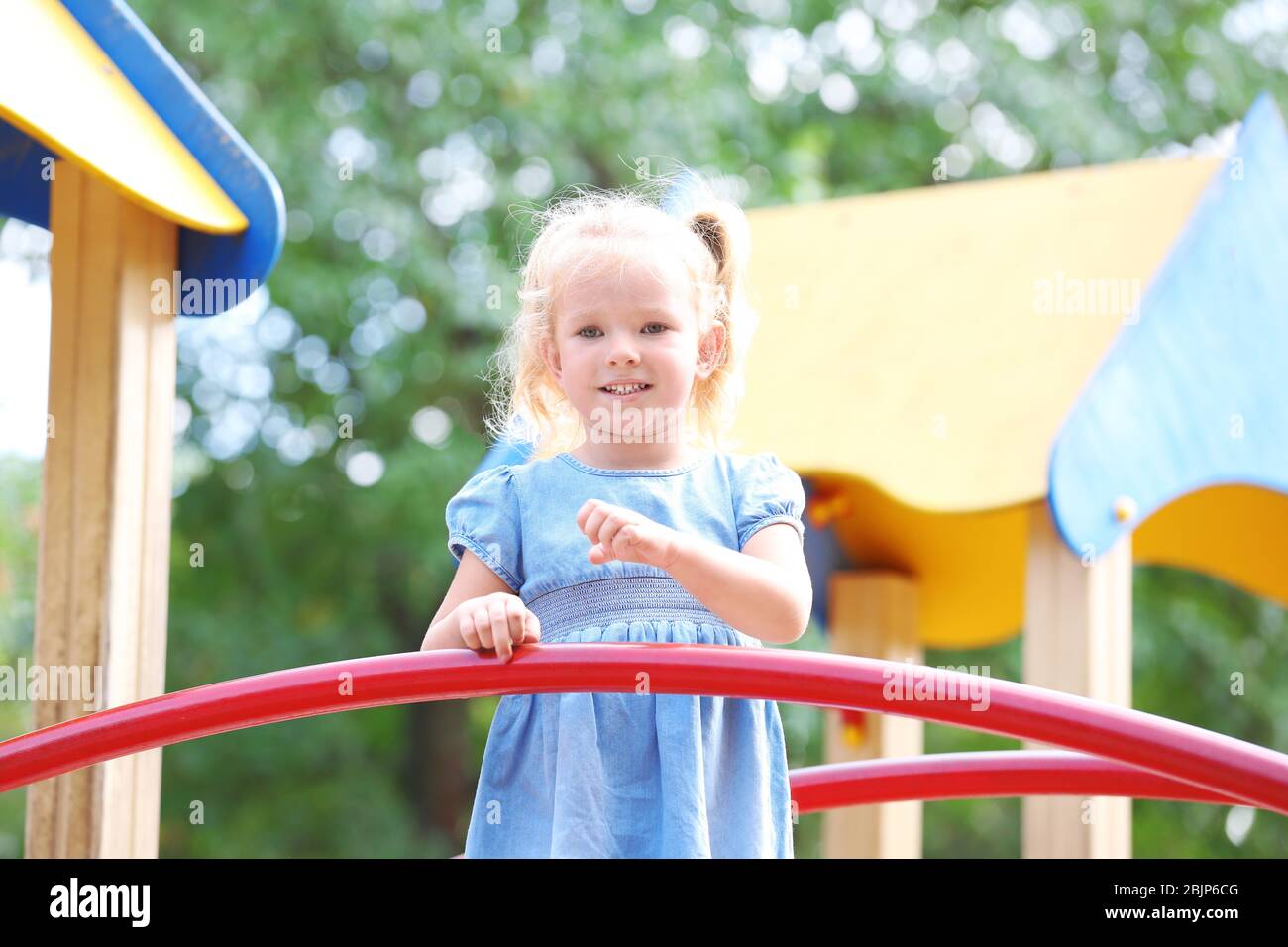 Adorable little girl on playground Stock Photo - Alamy