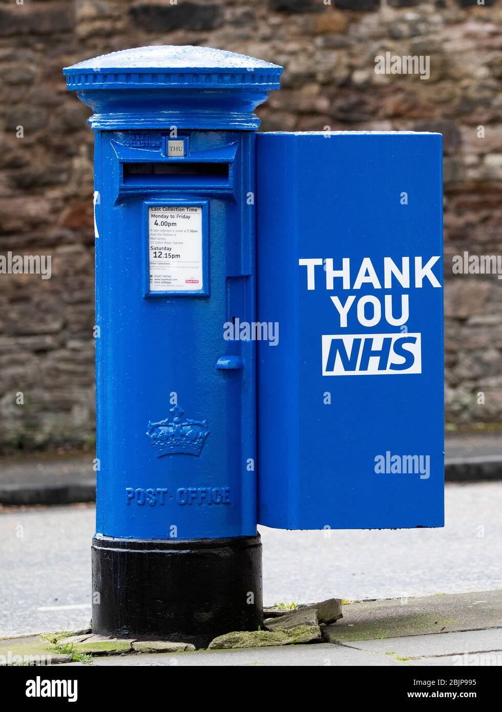 One of the specially decorated postboxes in Edinburgh painted blue in support of NHS workers and carers fighting the coronavirus pandemic. Stock Photo