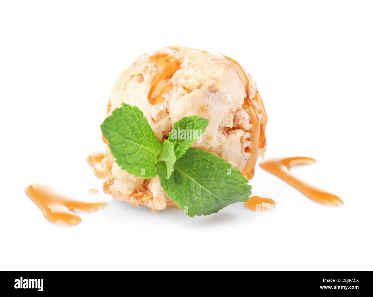 Scoop of ice cream with caramel topping and mint, isolated on white ...