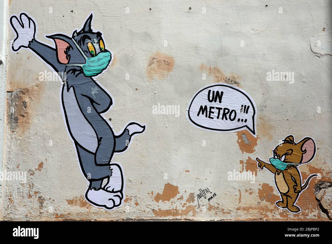 Mauro Pallotta, aka Maupal, created a new mural in Borgo Pio, a few meters from the Vatican and St. Peter's square. The work depicts the characters of the cartoon Tom & Jerry. Both Tom, the cat, and Jerry, the mouse, wear a mask. Jerry, who is usually chased by Tom, scolds the other and tells him to respect the safety distance, one meter (Alberto Lo Bianco/Fotogramma, Rome - 2020-04-30) p.s. la foto e' utilizzabile nel rispetto del contesto in cui e' stata scattata, e senza intento diffamatorio del decoro delle persone rappresentate Stock Photo