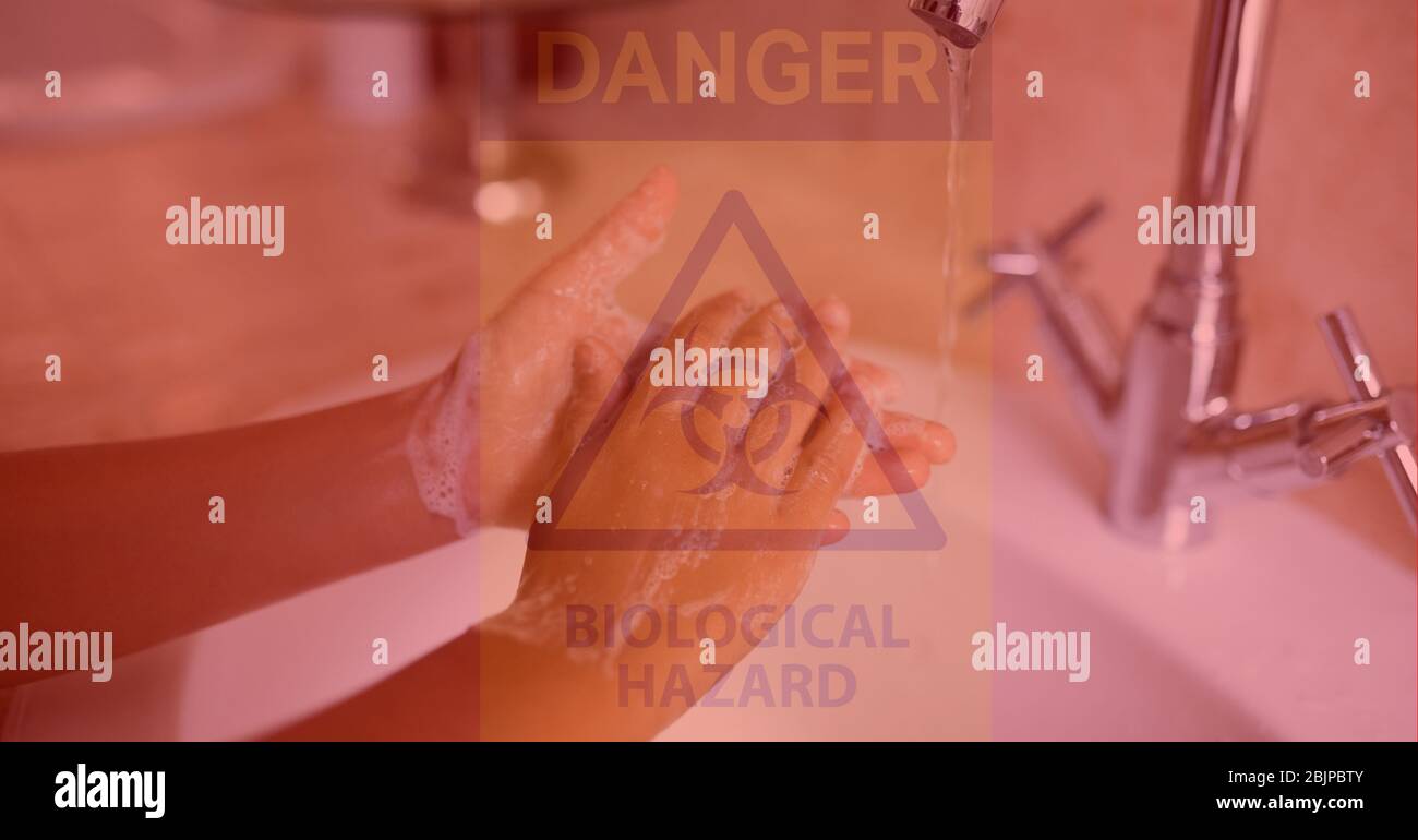Digital illustration of a person washing hands over a danger hazard sign with a Biological hazard si Stock Photo