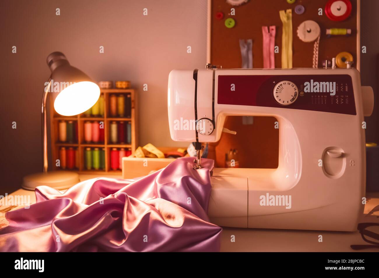 Sewing machine on table in Stock Photo Alamy