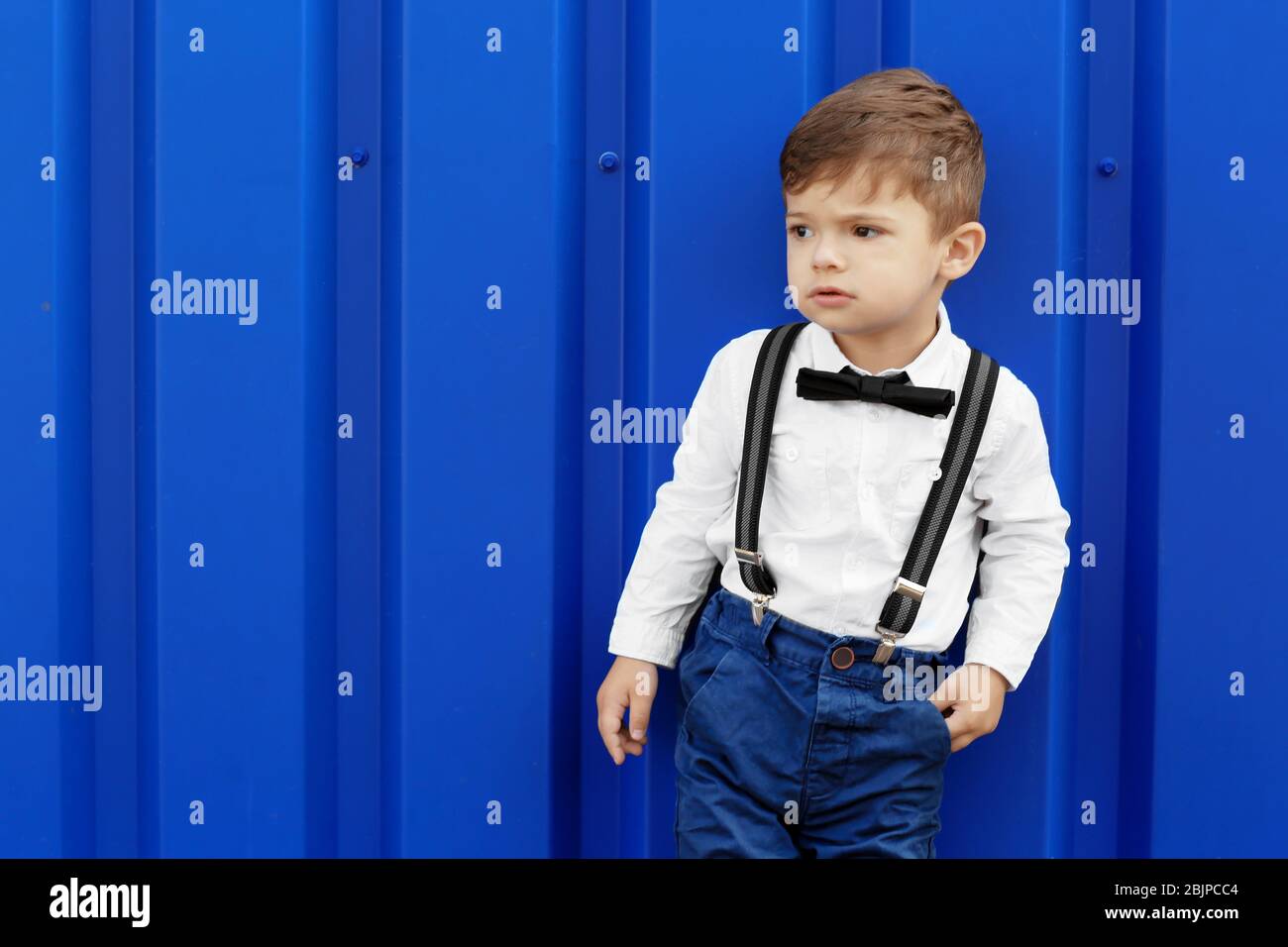 Little boy on blue background hi-res stock photography and images - Alamy