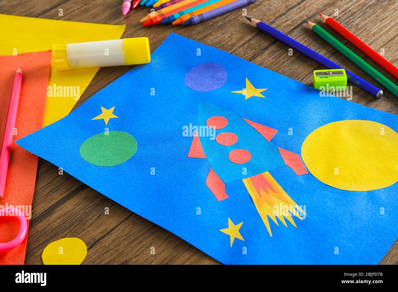 Child's applique of rocket on wooden table Stock Photo