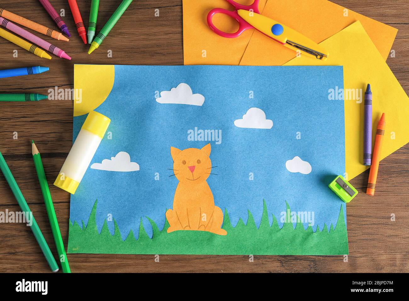 Child's applique of cat on wooden table Stock Photo