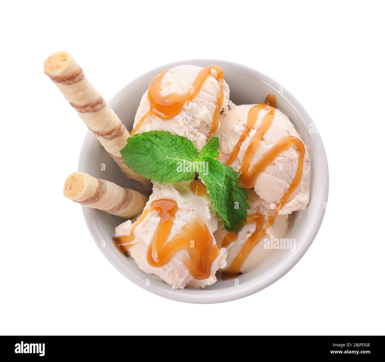 Bowl with caramel ice cream on white background Stock Photo - Alamy