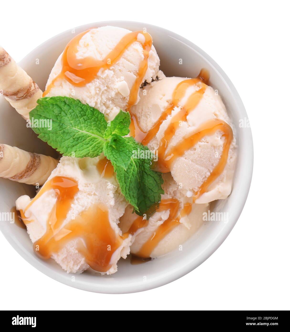 Bowl with caramel ice cream on white background Stock Photo - Alamy