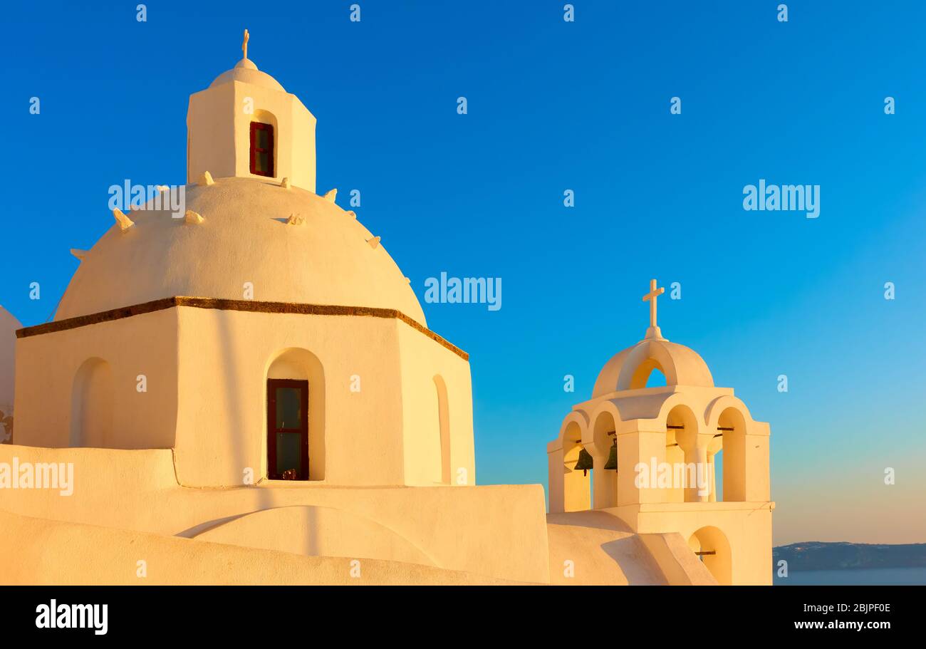 Domes of greek church in Santorini island in the light of the  sunset sun, Greece Stock Photo