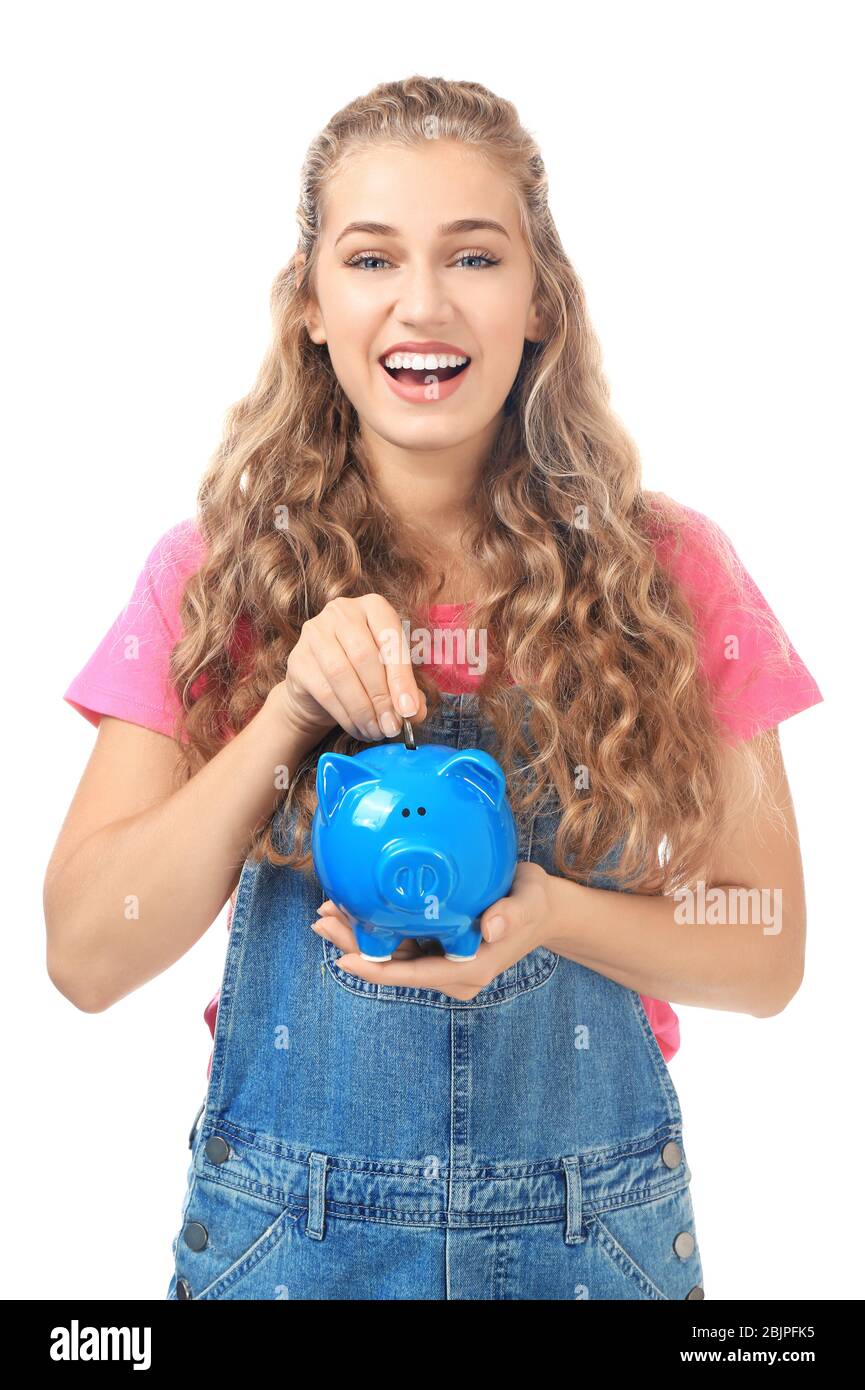Young woman putting coin into piggy bank on white background Stock ...