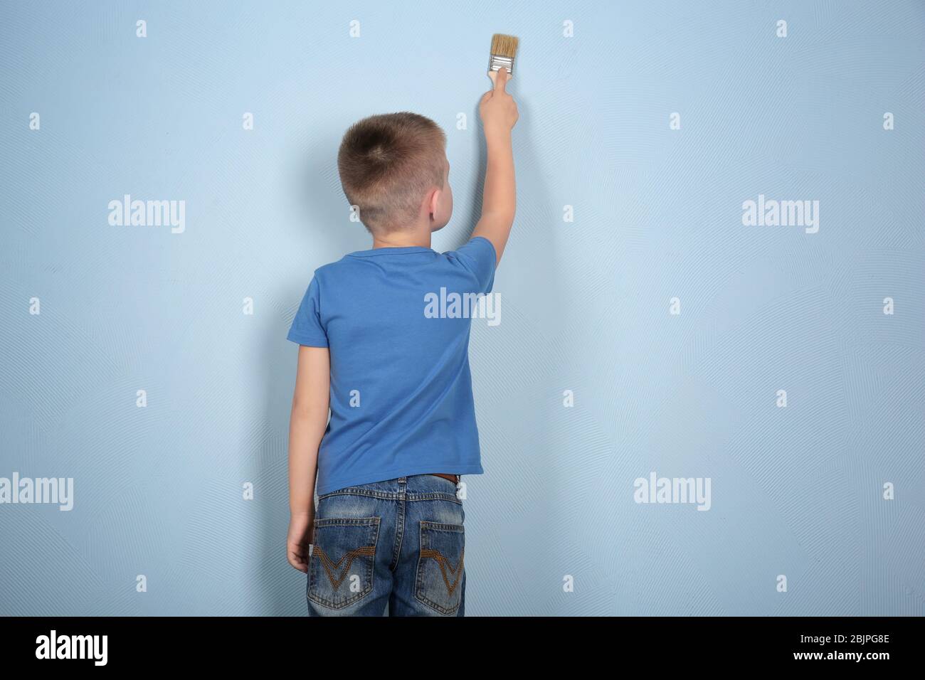 Cute little boy painting wall Stock Photo Alamy