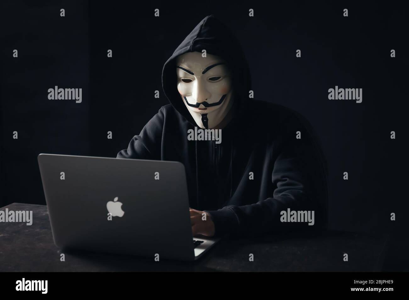 Hacker anonymous mask using laptop hi-res stock photography and images ...