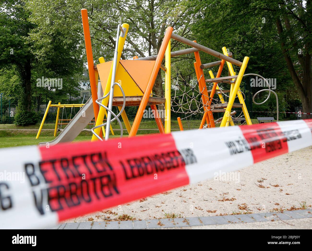 Essen, Germany. 30th Apr, 2020. A public playground is closed off with flutterband. According to the federal government's bill, the playgrounds, which have been closed for weeks, should be able to be reopened. Parents should take care to avoid overcrowded facilities and observe basic rules of hygiene. Credit: Roland Weihrauch/dpa/Alamy Live News Stock Photo