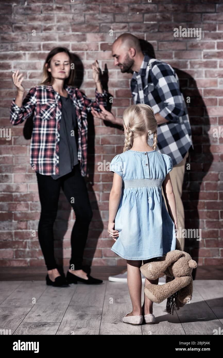 Little girl and arguing parents against brick wall Stock Photo Alamy