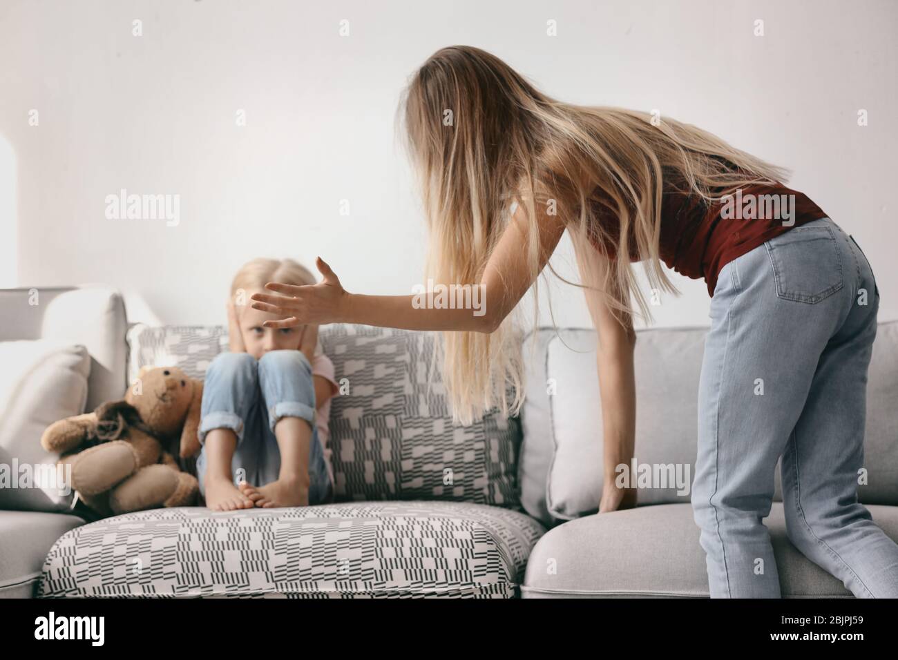Young woman abusing her daughter at home Stock Photo - Alamy